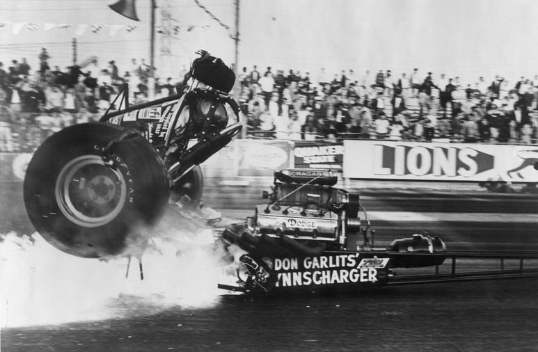 March 8, 1970- Don Garlits shown sitting between the tires the moment the engine of his dragster exploded, splitting the car in half and blowing off his right foot. The accident led the legendary driver to redesign rear-engine vehicles that revolutionized the sport.