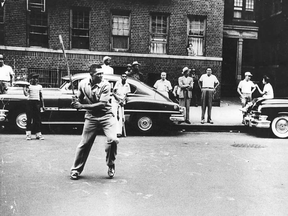 Willie Mays playing stickball on the streets of Harlem in the 1950s. A familiar urban scene for much of the 20th century, stickball by the 1980s gave way to shifting cultural patterns and more recreational options.
