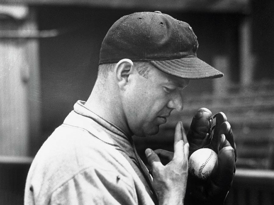 Burleigh Grimes wetting his fingers before launching a spitball pitch. 17 pitchers were grandfathered after the ban and Grimes was the last to hurl a legal spitball when he retired in 1934.