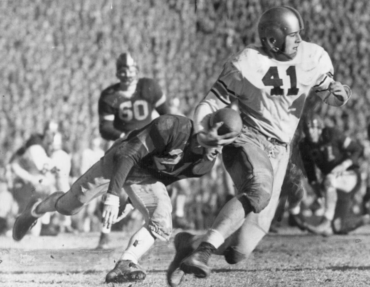 Army's Glenn Davis eludes Navy tacklers at the 1944 Army-Navy game. Army won 23-7 and the two academies would never meet again for the college football championship.